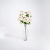 three cloudy artificial ranunculous stems in glass vase