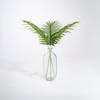 Three artificial paradise leaf stems in glass vase
