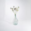 Three artificial thistle stems in glass vase