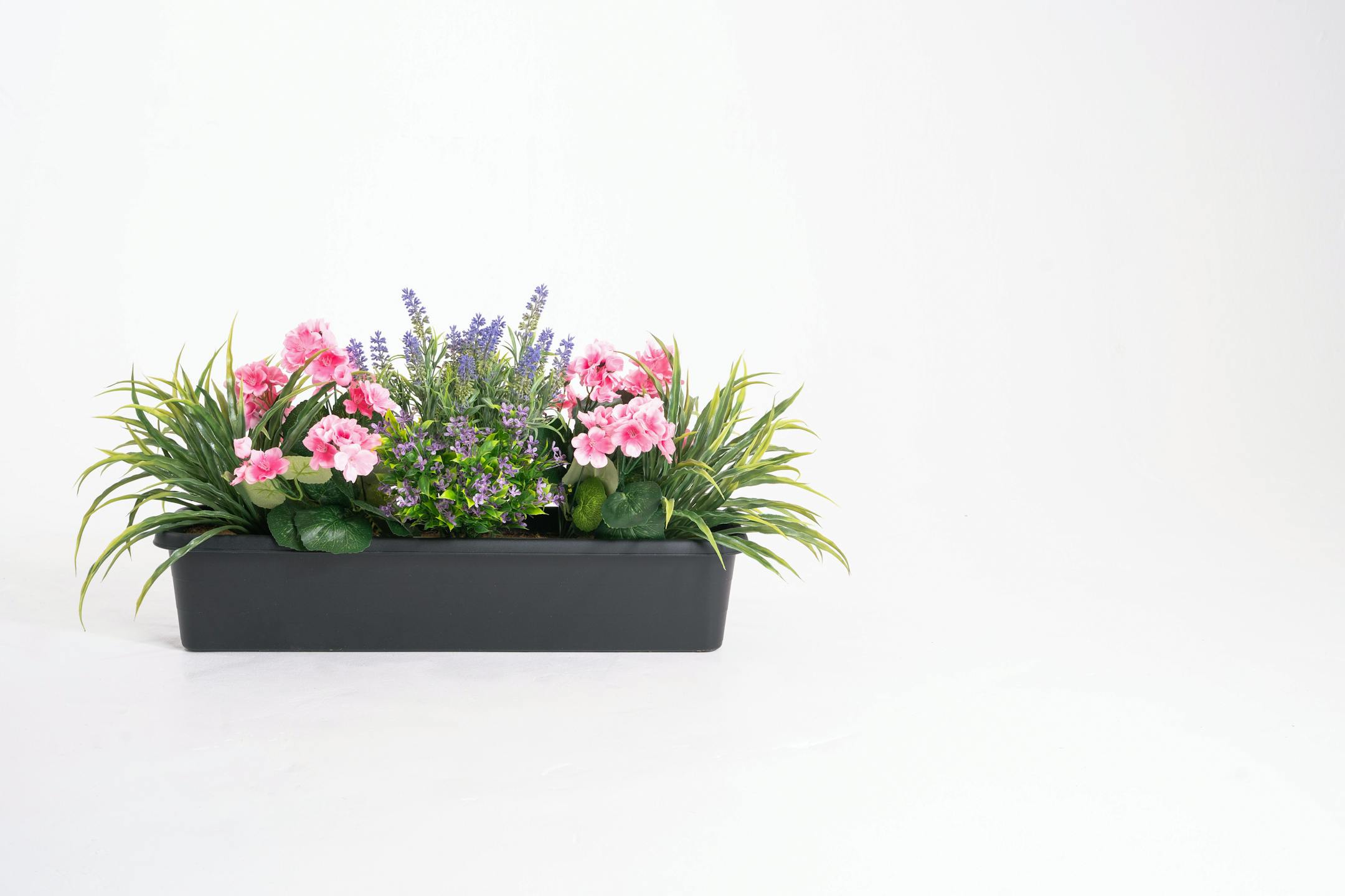 Artificial pink and purple mixed flower window box