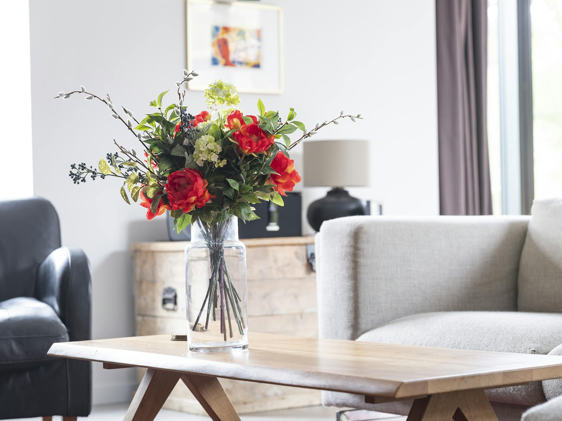 Artificial regal bouquet on oak coffee table in living room