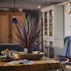 Artificial cordyline grass plant sitting on rustic oak dining table in Alexandra Barn