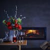 Faux regal bouquet in dark room with fireplace