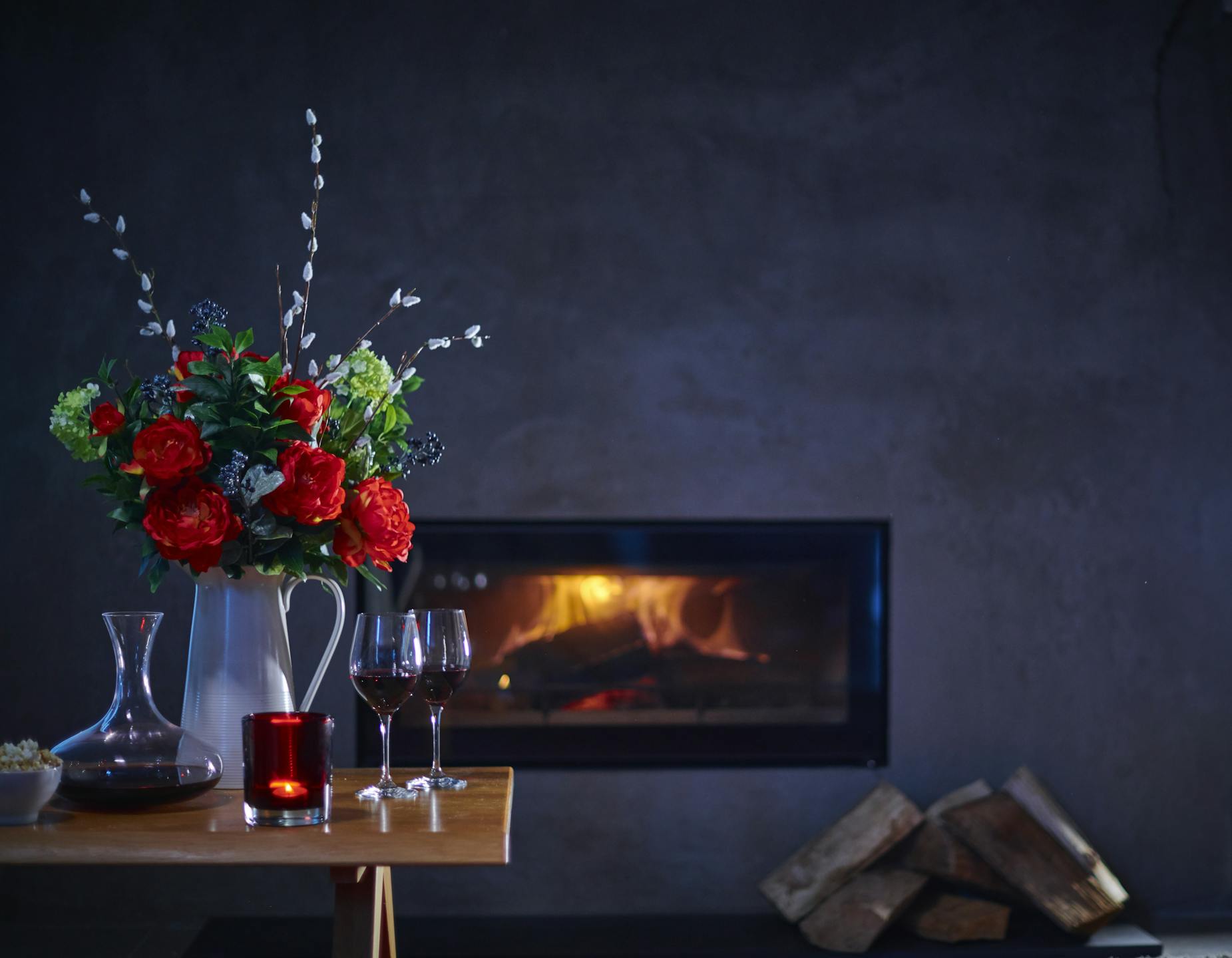Faux regal bouquet in dark room with fireplace