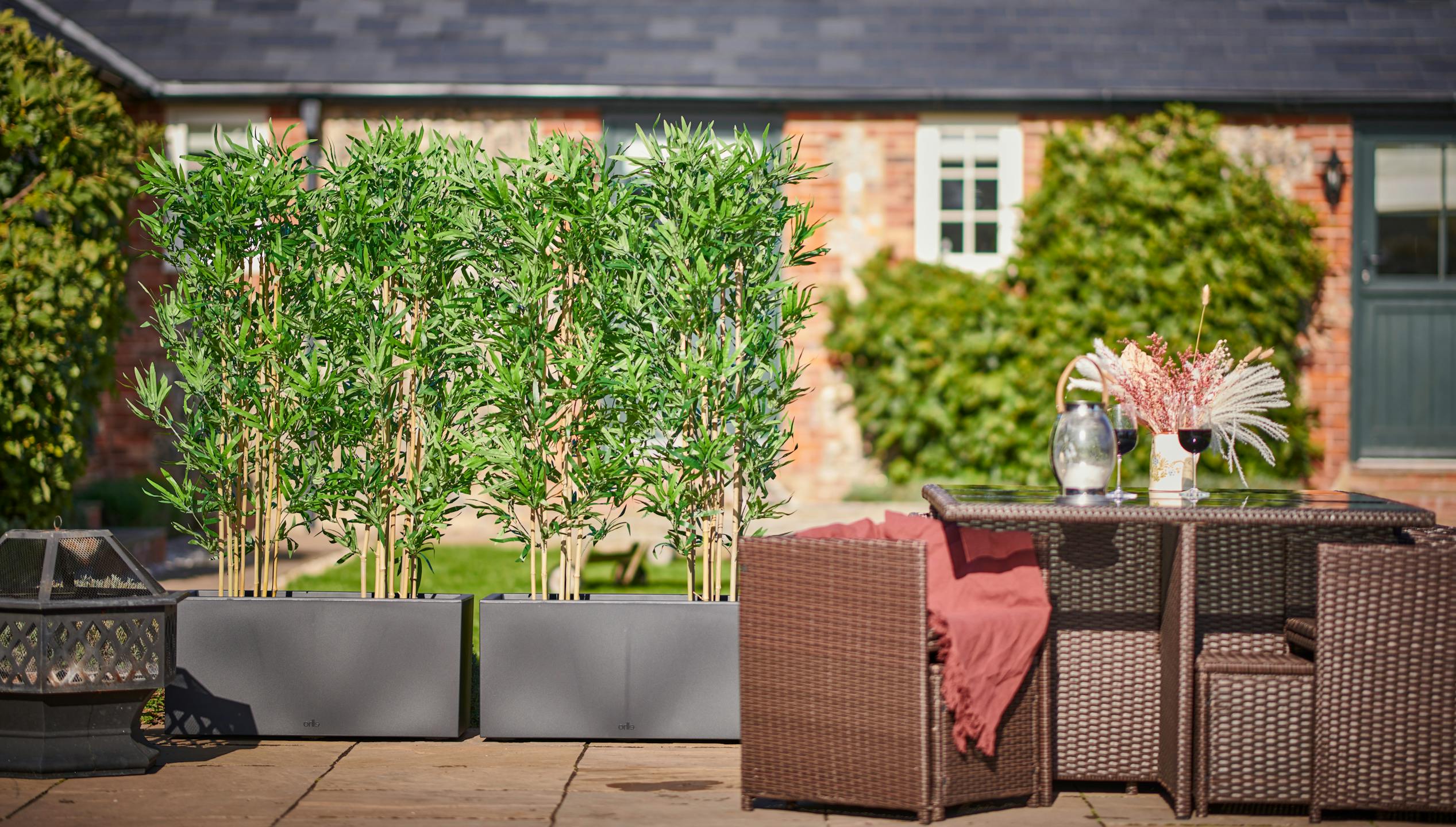 Blooming Artificial bamboo screening planters at Bodney Lodge gardens