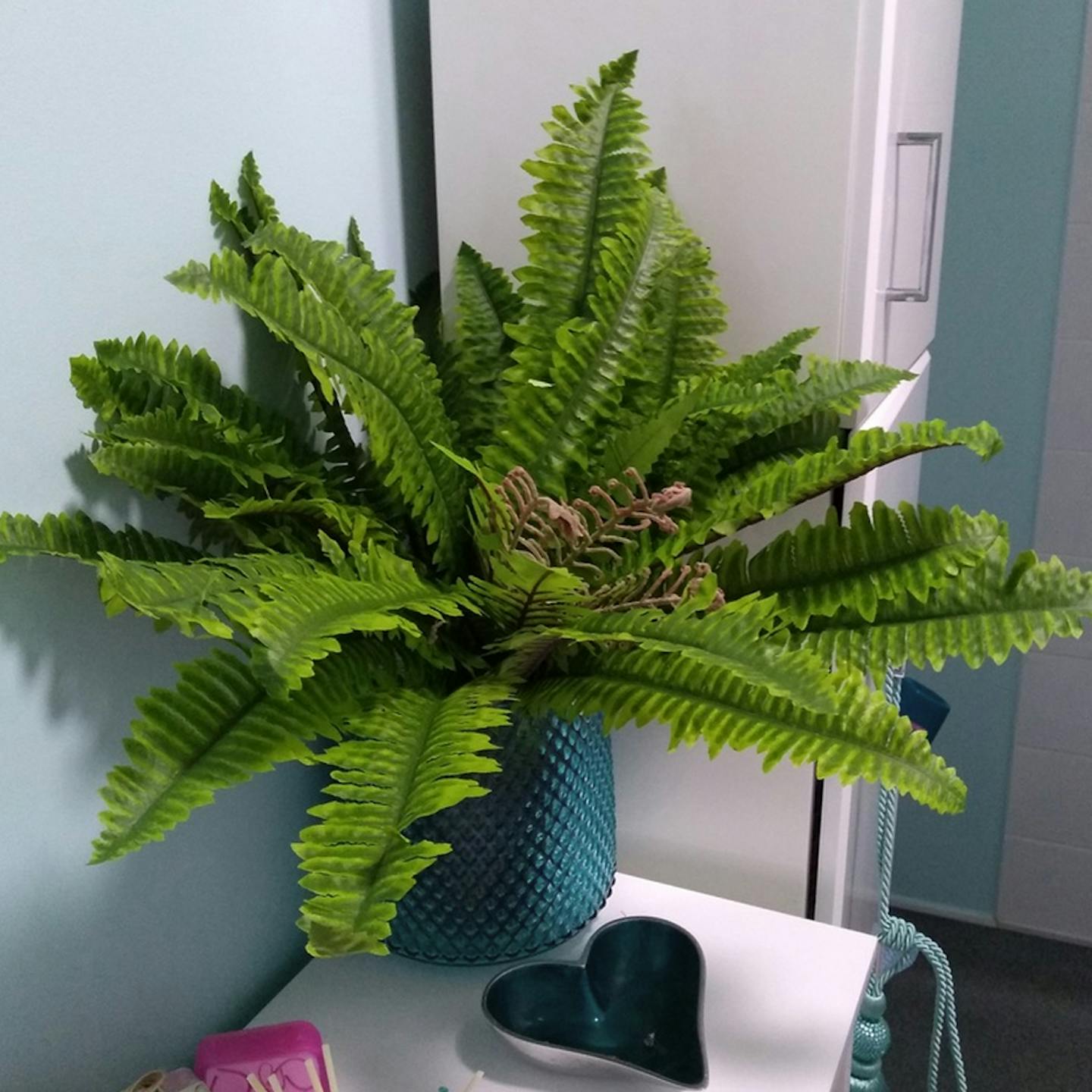 Artificial Boston fern in decorative blue planter