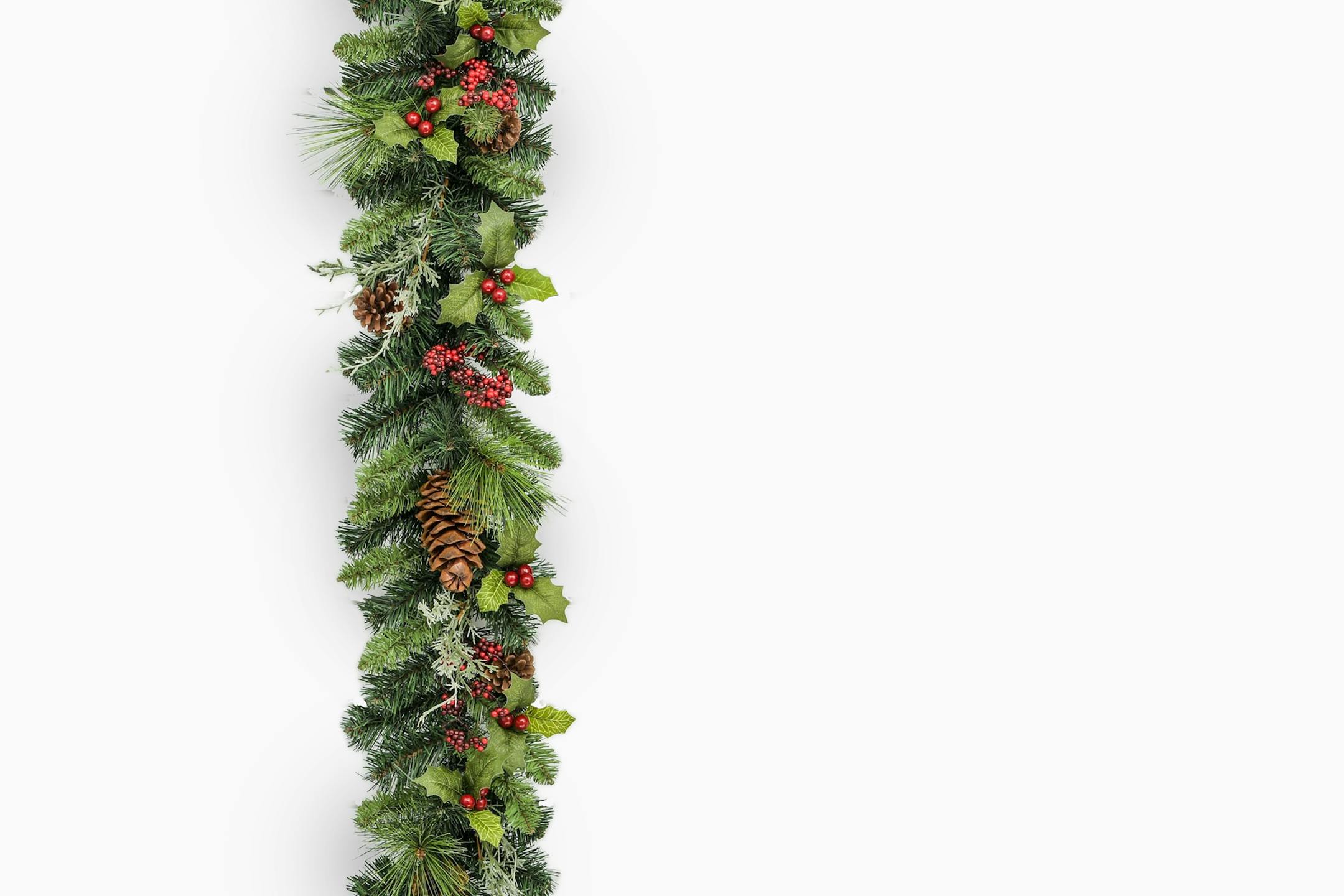 Artificial winter berry holly and pinecone garland on white background