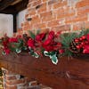 Artificial Christmas fiesta garland on wooden mantelpiece