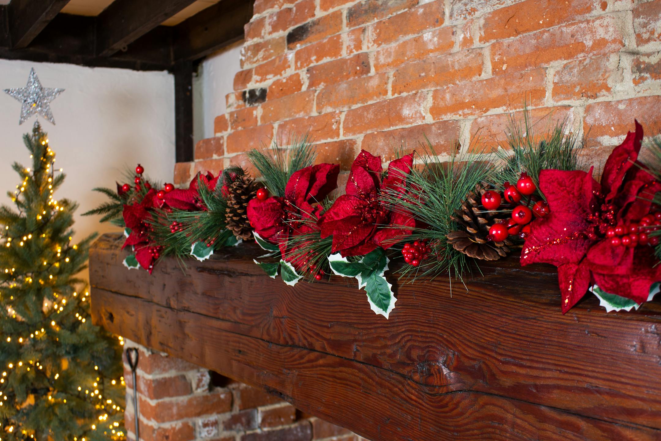 Artificial Christmas fiesta garland on wooden mantelpiece