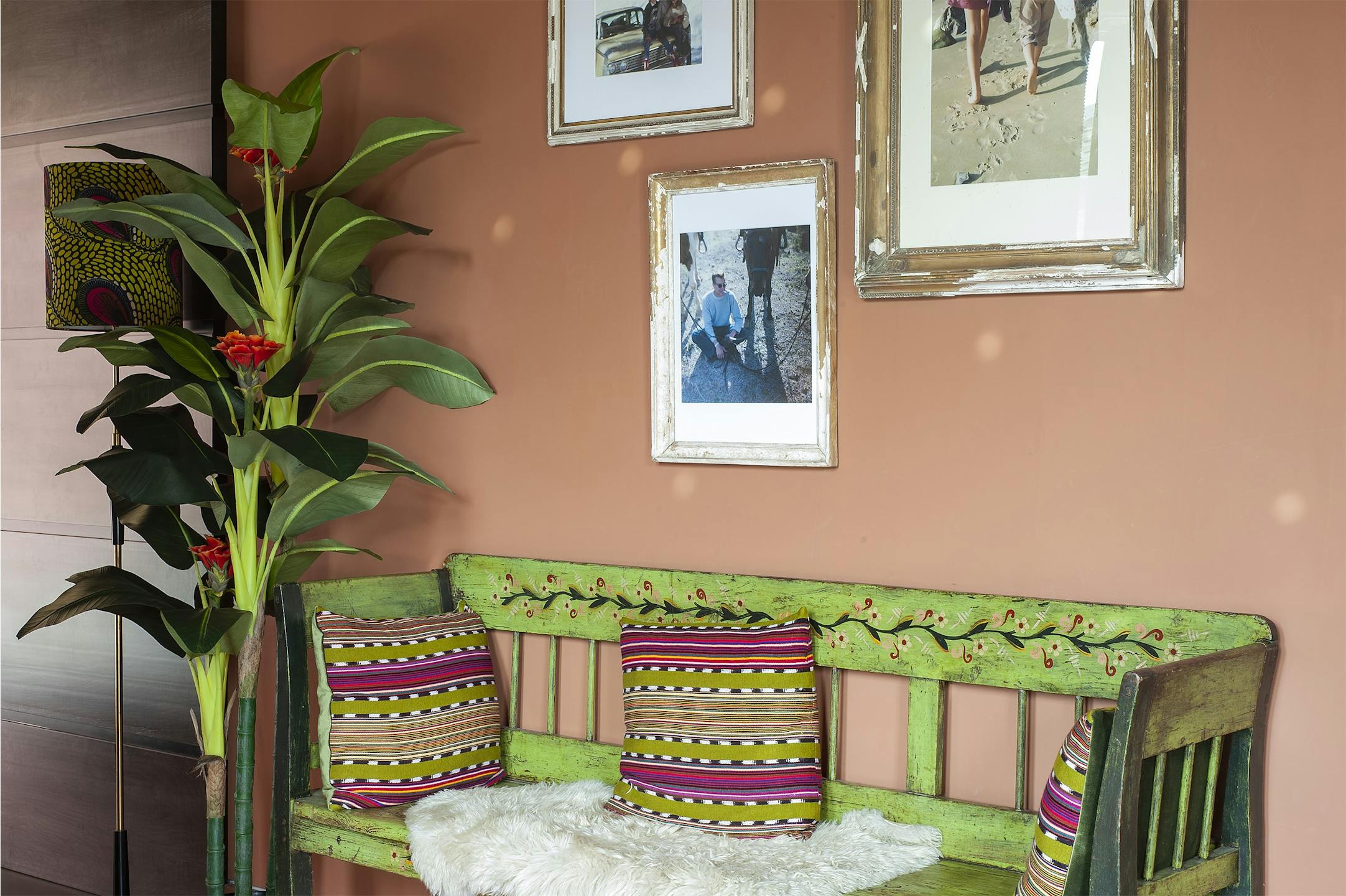 Faux banana tree with green bench