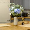 Artificial blue hydrangea bouquet on kitchen table