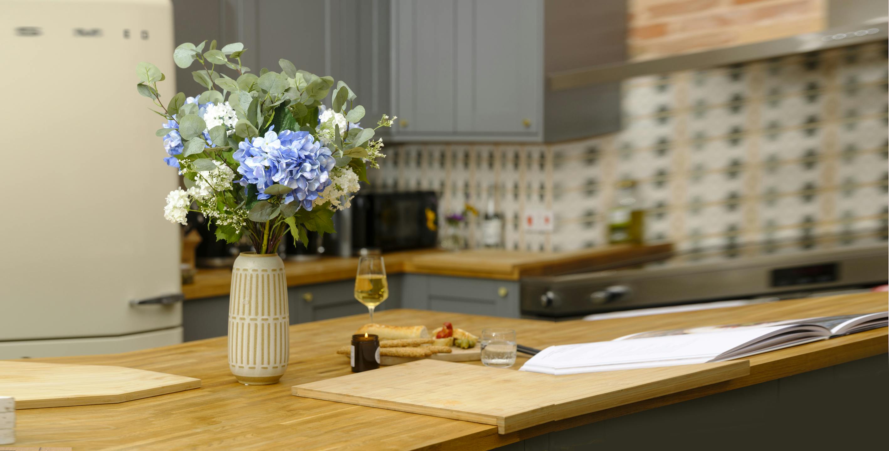 Artificial blue hydrangea bouquet on kitchen table
