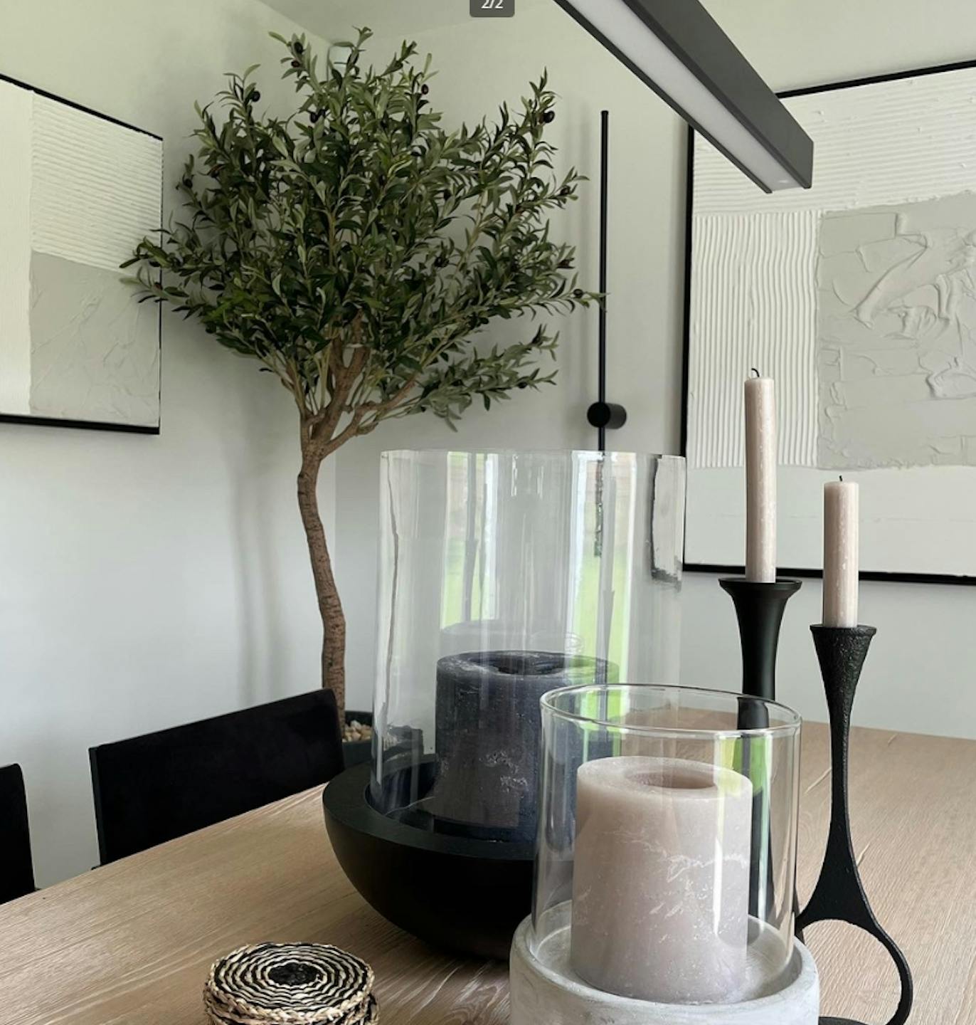 Artificial Ligurian olive tree stood near wooden dining table