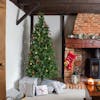 Artificial Minnesota pine Christmas tree next to fireplace