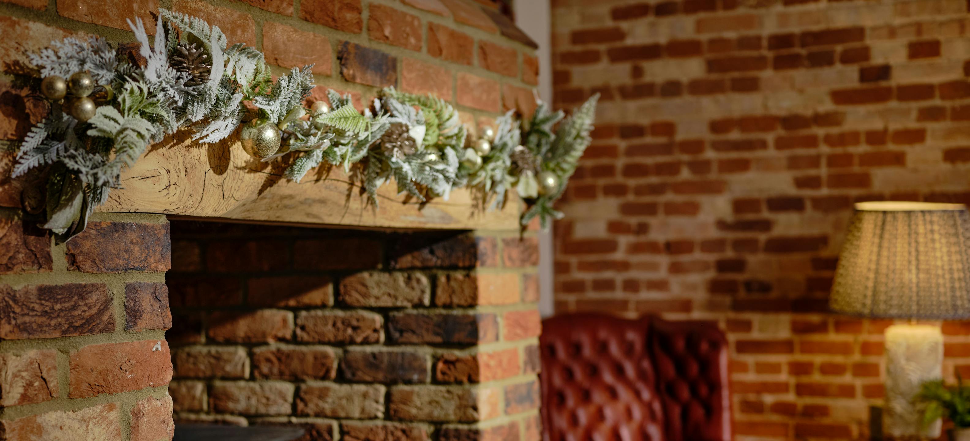 Nordic white and gold festive garland over fireplace