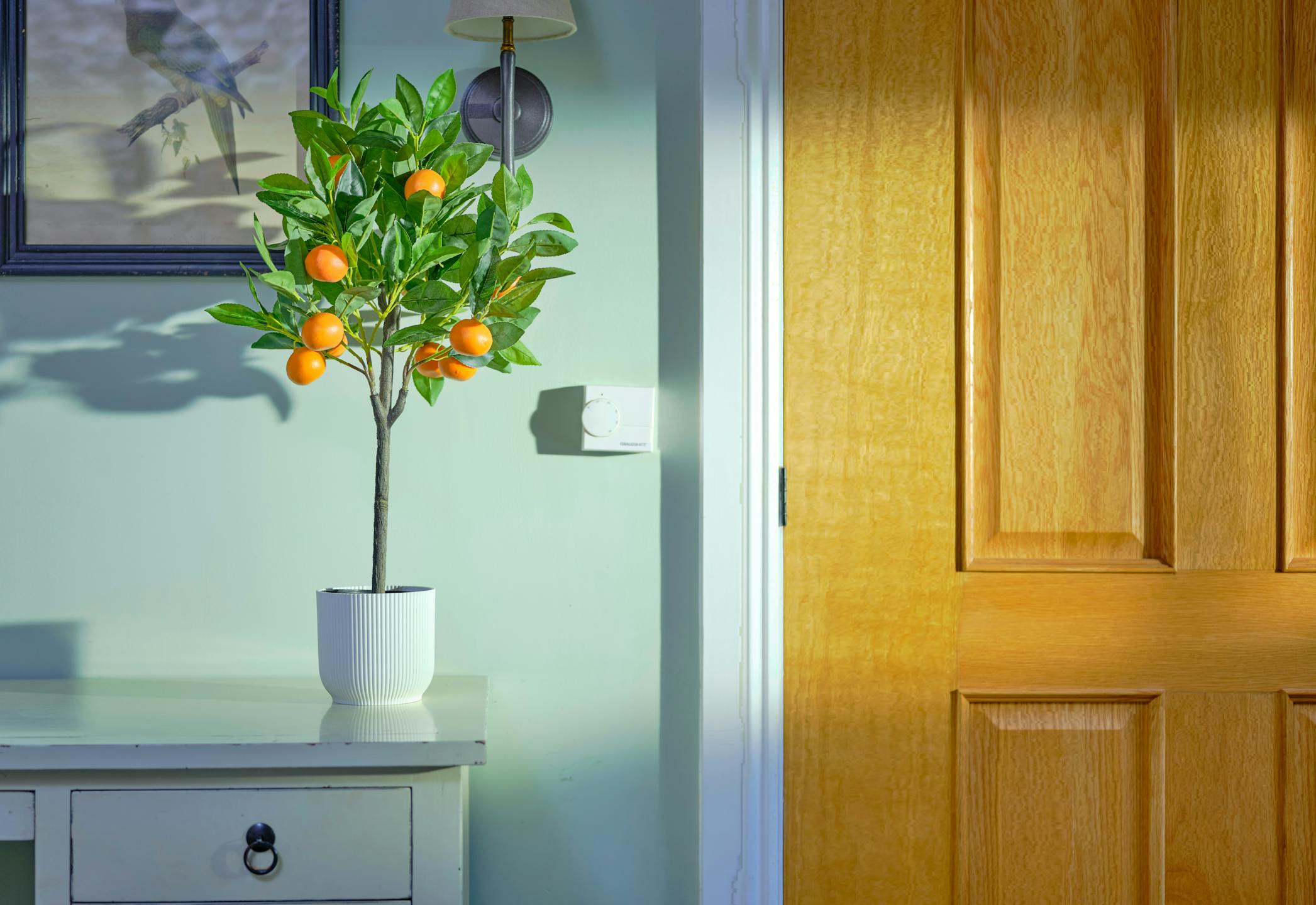 Small artificial orange tree on bedroom dressing table