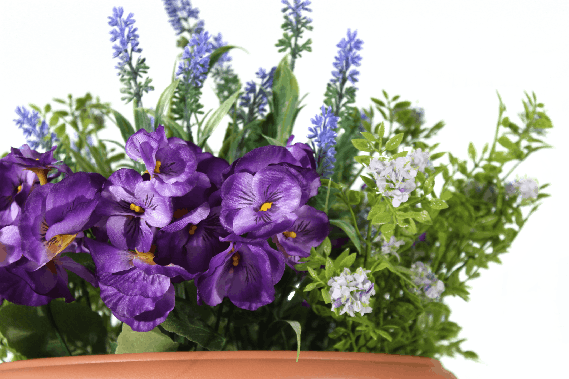 Artificial purple pansy and lavender patio planter close up