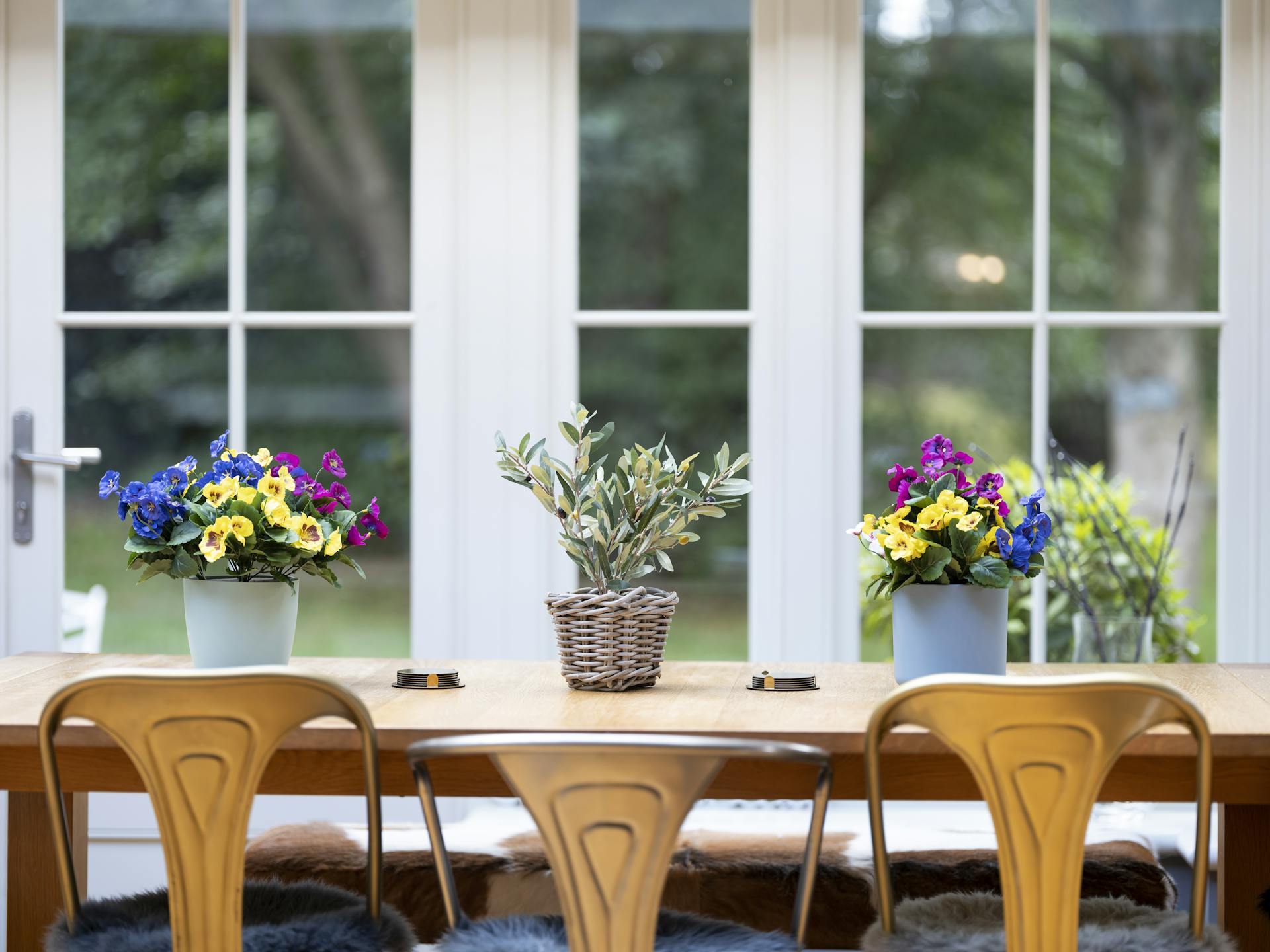 Artificial pansy bush arrangement on dining table