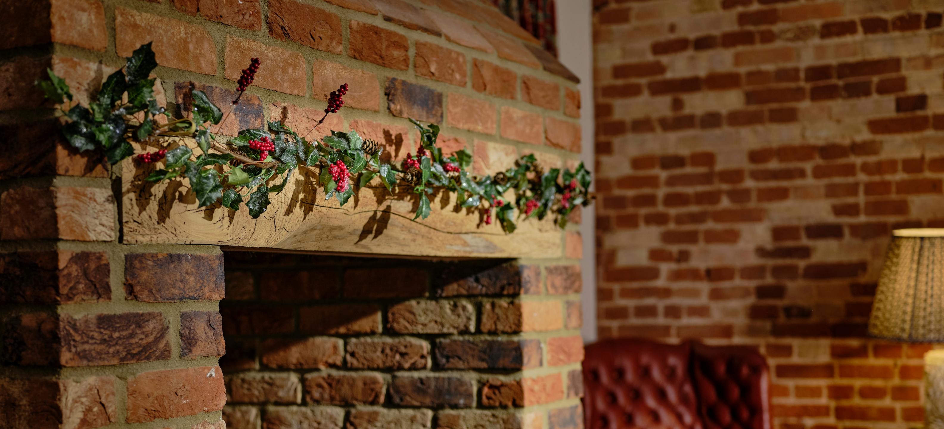 Pure holly garland green and red over fireplace