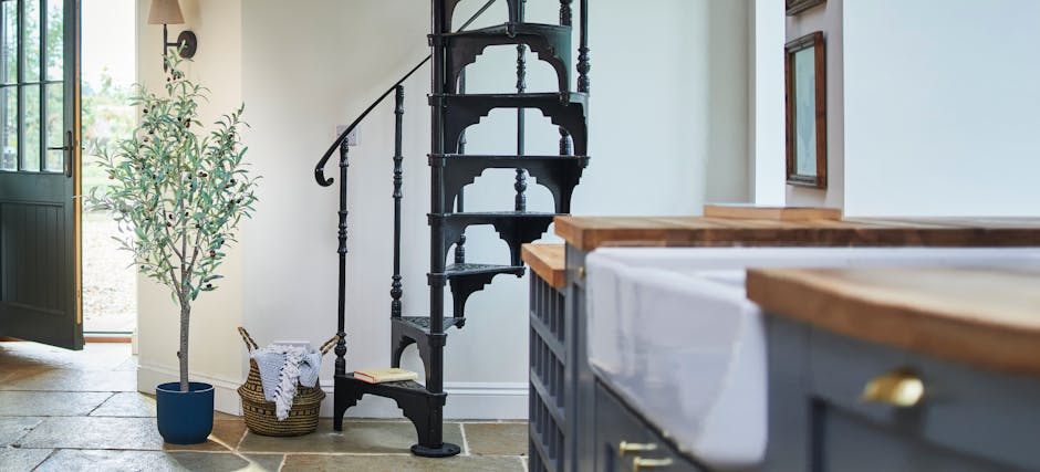 Tuscan-style artificial olive tree in kitchen by spiral staircase