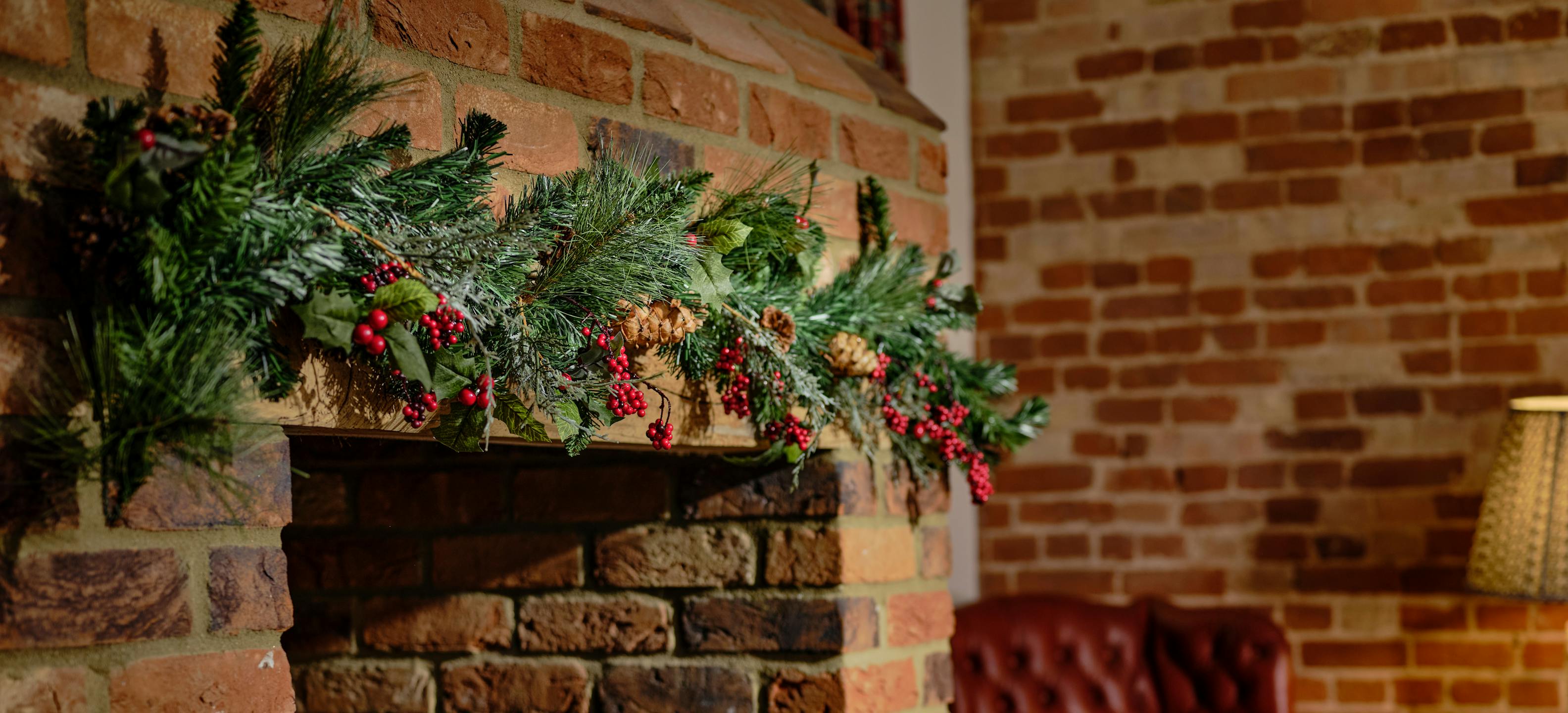 Winter berry style traditional Christmas garland over fireplace