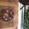Artificial winter spice wreath on wooden door