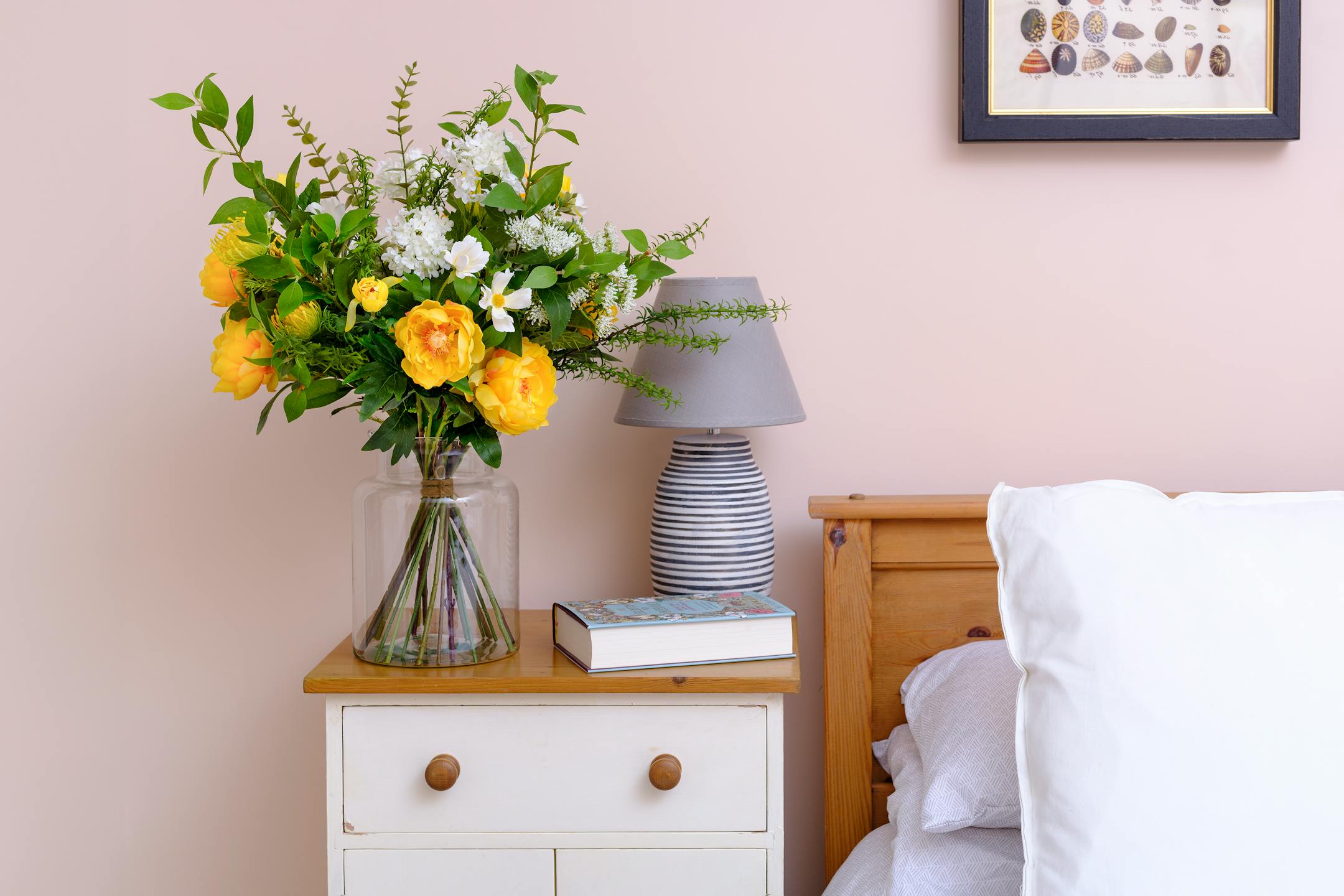 Yellow artificial sensational bouquet in pink bedroom