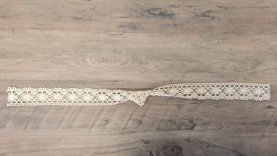Woven lace ribbon with a knot in the centre