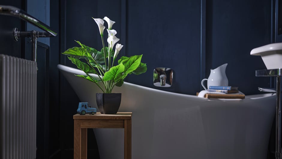 Artificial white calla lily in dark blue bathroom