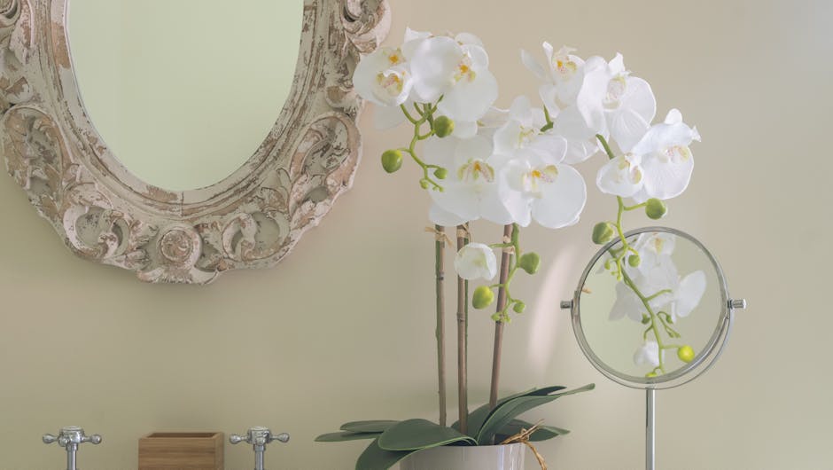 White artificial phalaenopsis orchid on bathroom sink