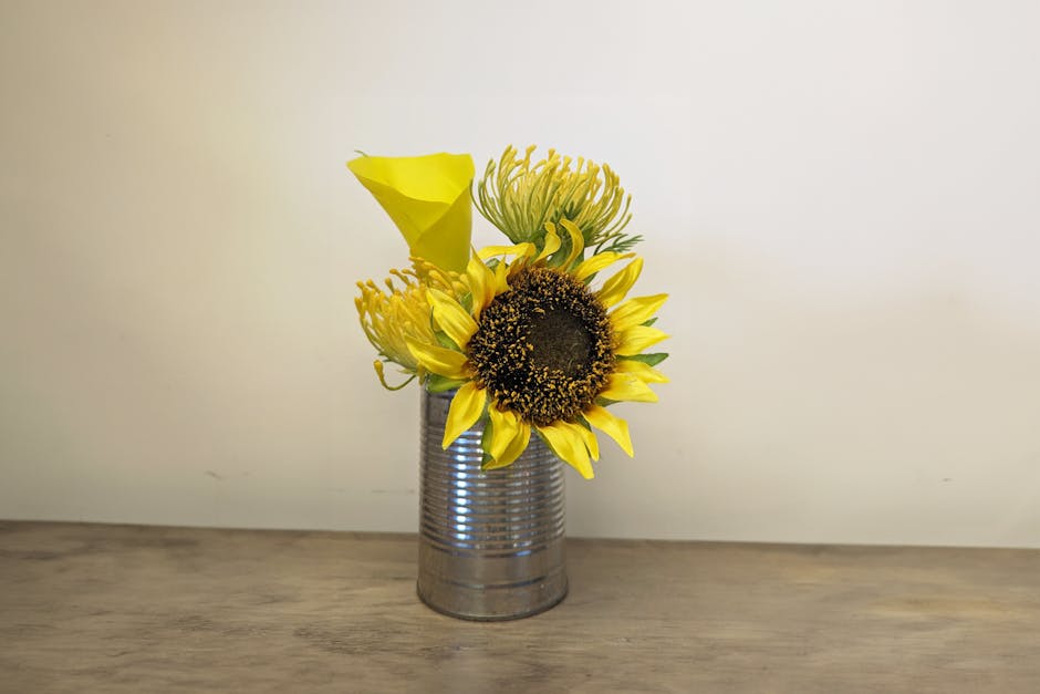 Small, yellow floral arrangement in can