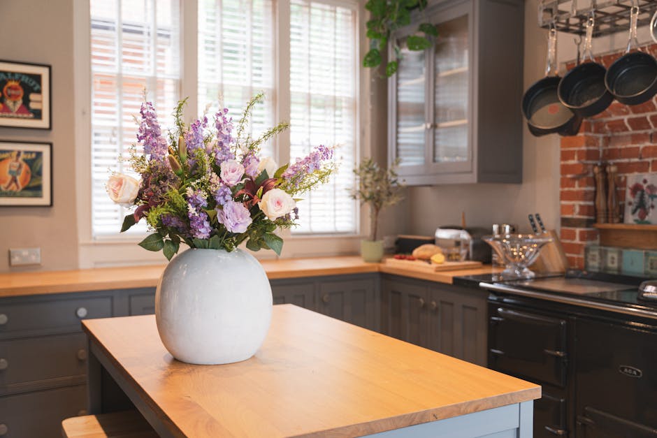 Artificial amethyst bouquet on wooden kitchen island in cement vase