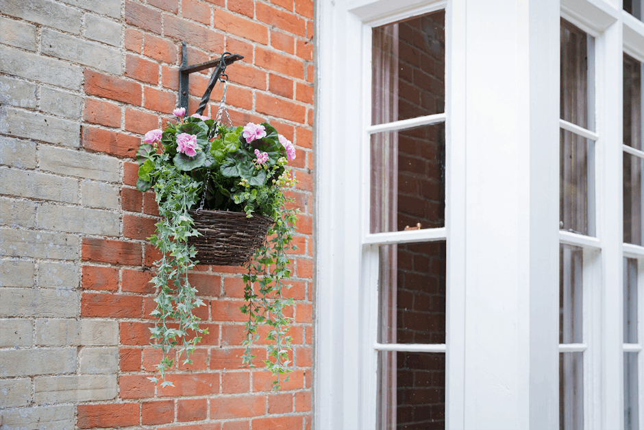 Artificial pink wild berry & geranium hanging basket by Blooming Artificial